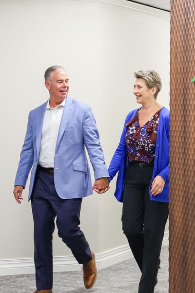 Sean and Angela Kouplen walking down hallway